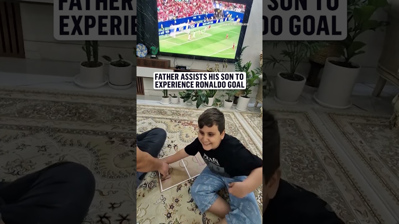 A dad making sure his son doesn't miss any part of the game